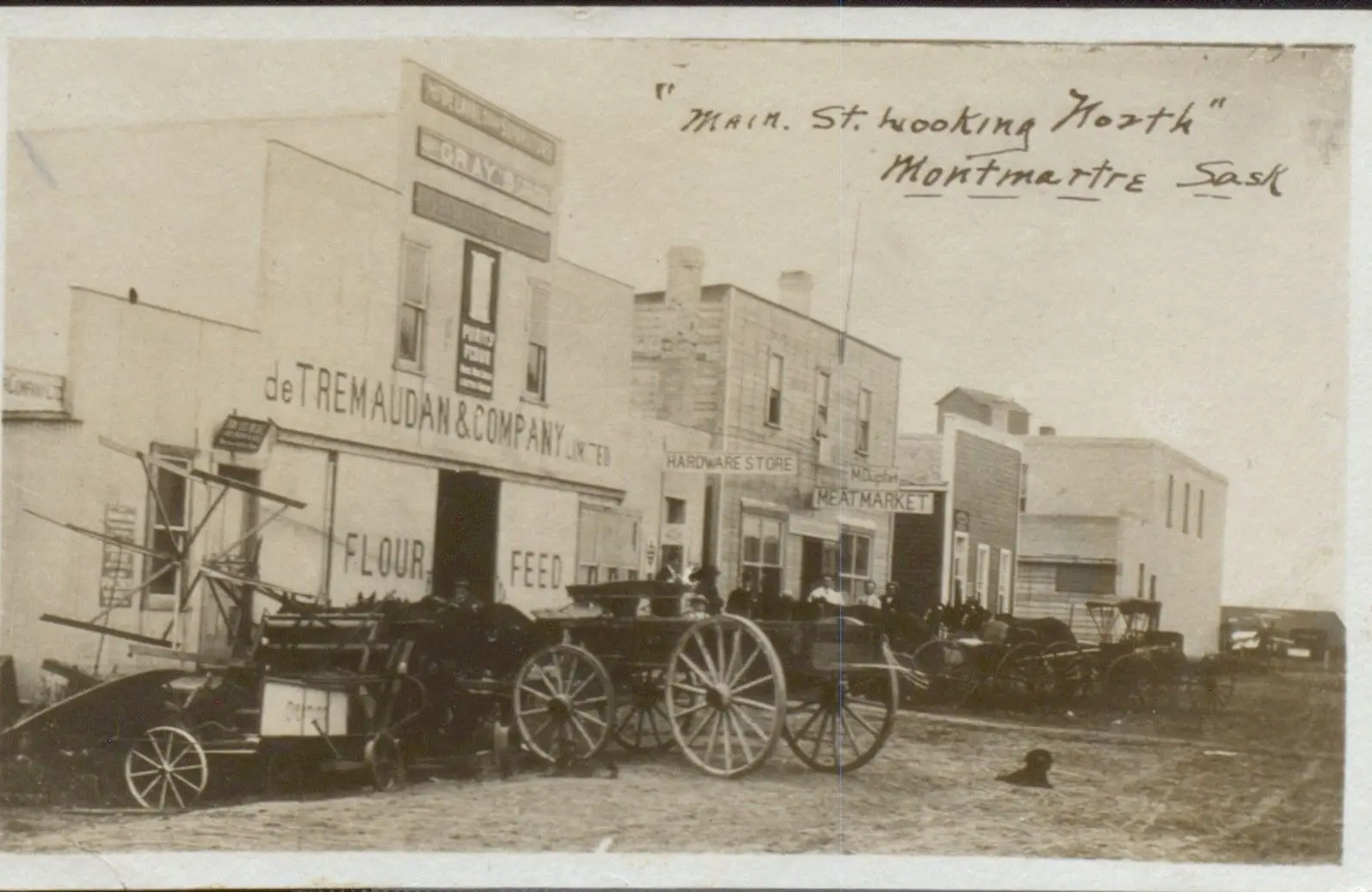 Main Street looking north, with storefronts and wagons